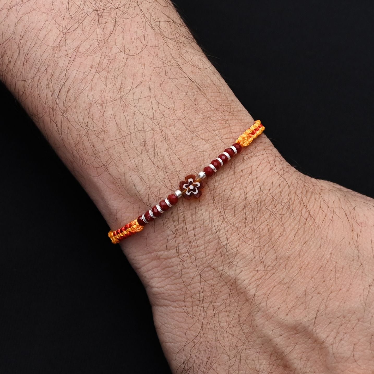 Elegant brown flower design with silver and light brown beads, perfect Rakhi for boys.