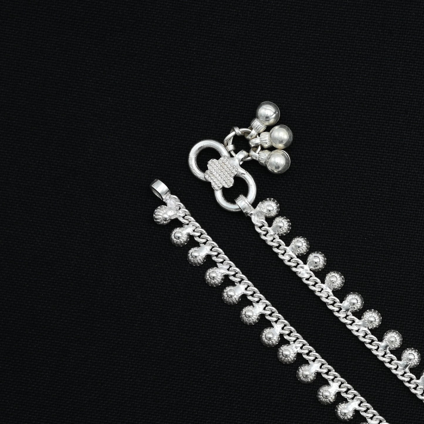 Silver anklet with a delicate, minimal design highlighted by a solitaire stone.