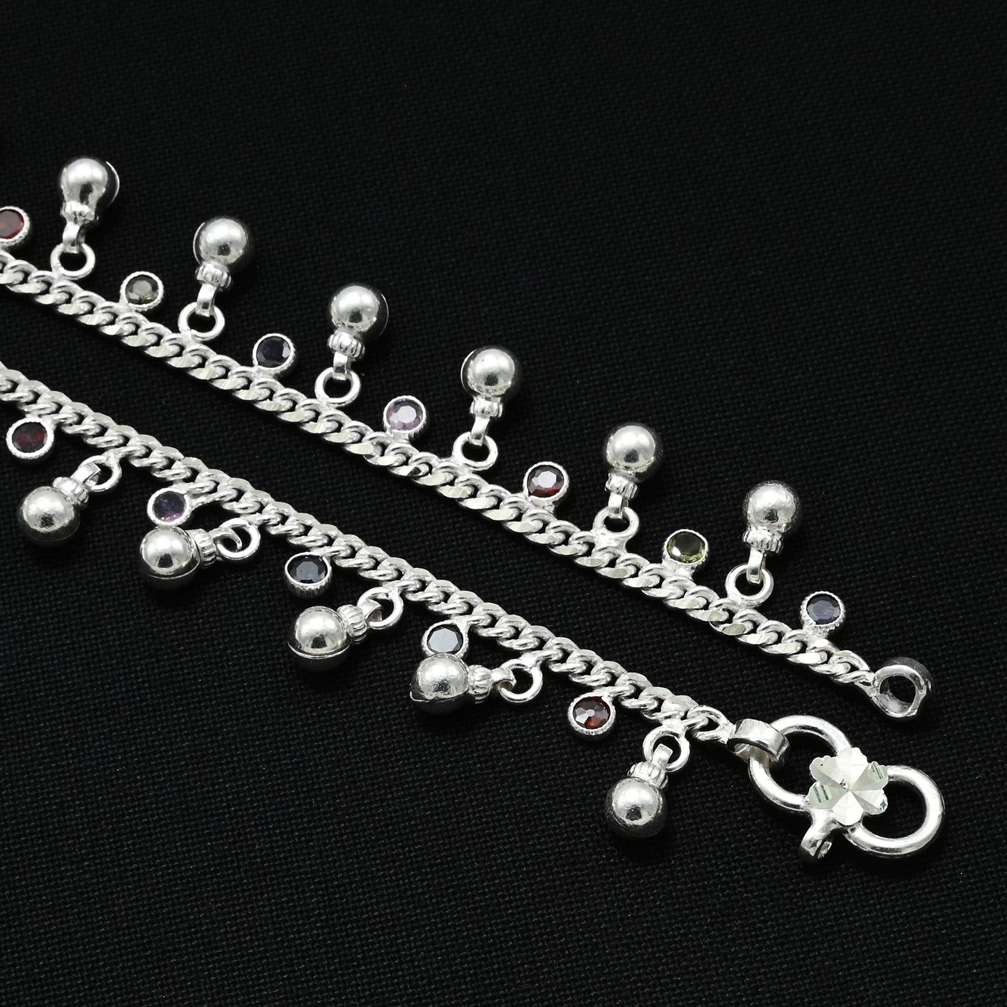 Silver anklet adorned with large beads and sparkling gems for a luxurious touch