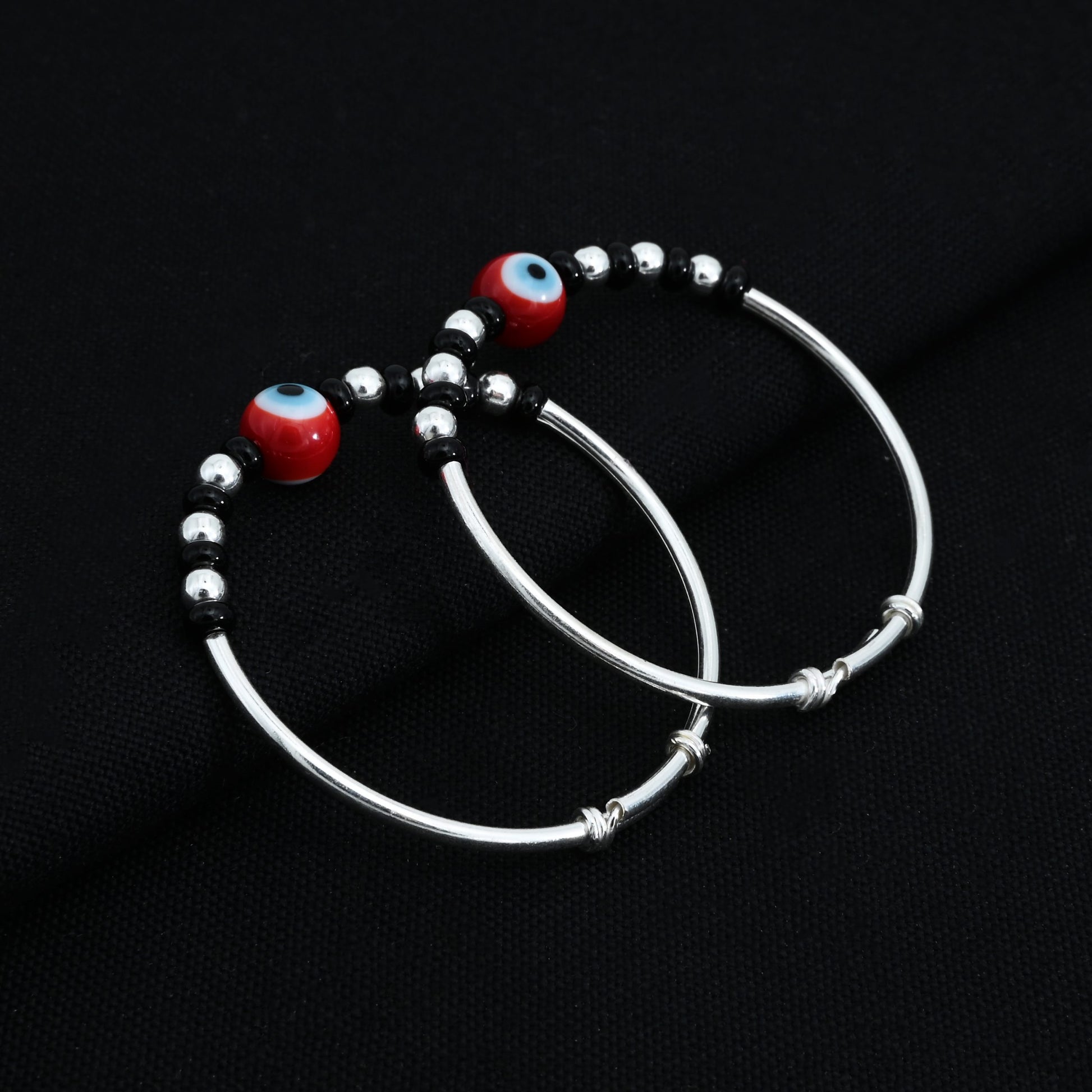 Charming silver baby kada with black beads and a protective evil eye symbol