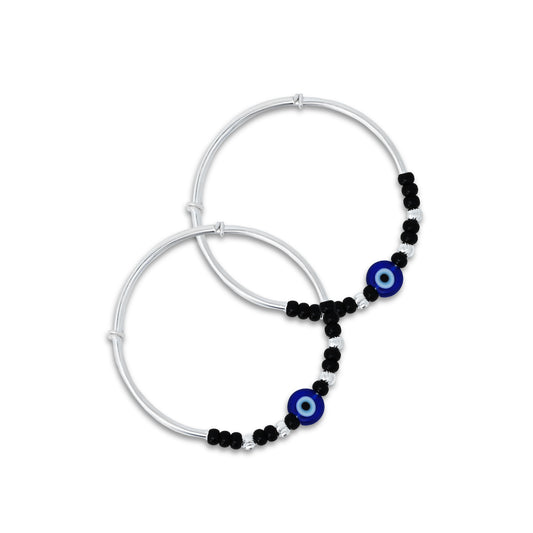 Silver baby kada payal featuring a blue evil eye with black and silver beads.