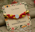 Silver center Swashtika design with red and yellow tangle Moli, perfect Rakhi for boys.