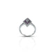 Elegant silver ring with vibrant white and purple stones.