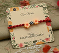 Silver center bead design with orange flowers, perfect Rakhi for boys.