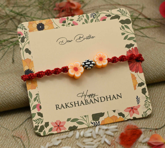 Silver center bead design with orange flowers, perfect Rakhi for boys.