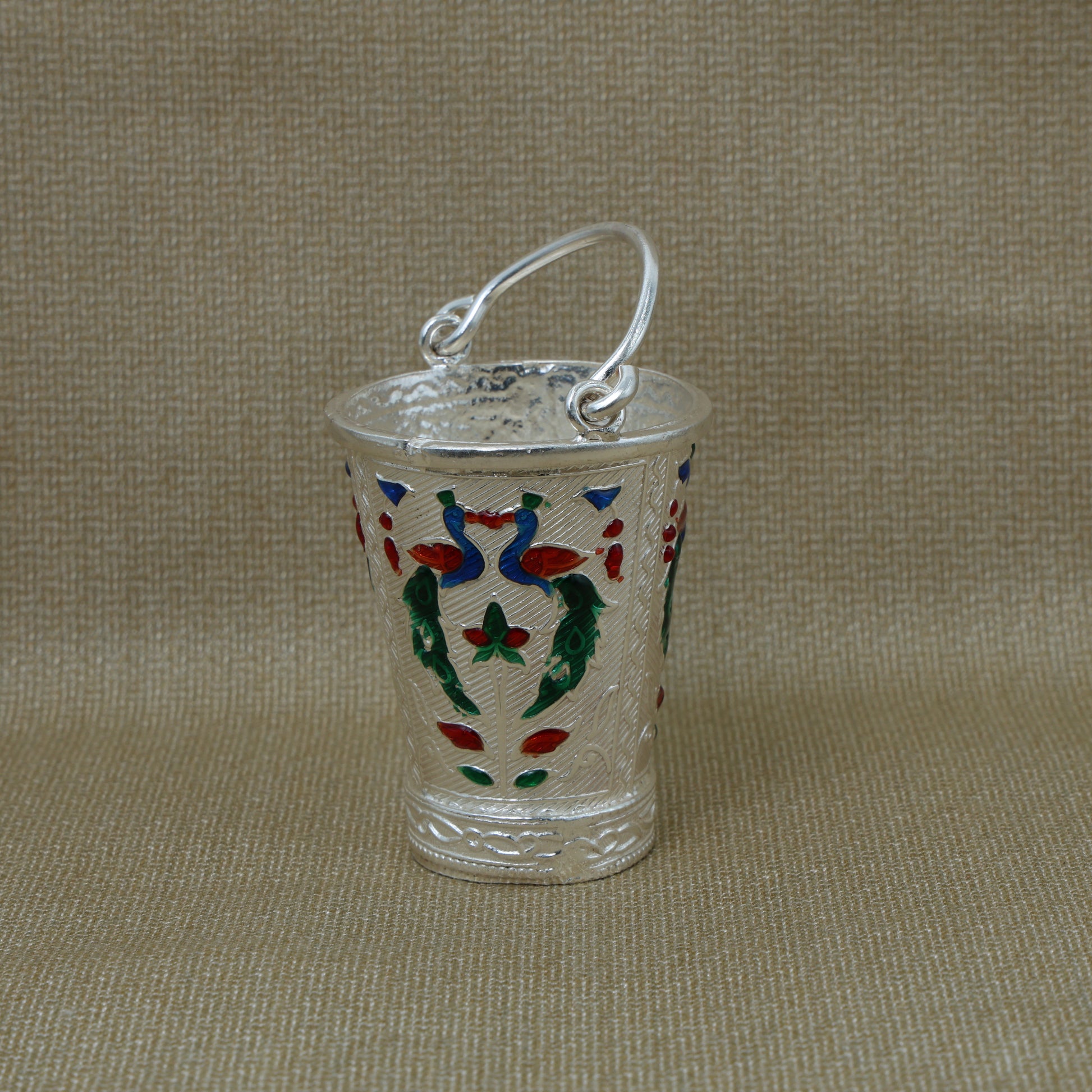 High-quality image of the silver bucket with intricate peacock design, perfect for use in spiritual practices.