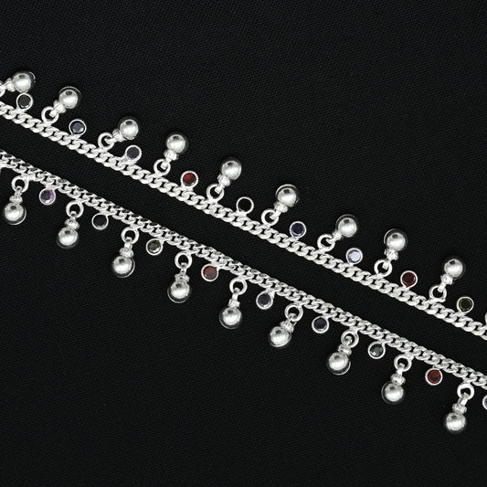 Silver anklet adorned with large beads and sparkling gems for a luxurious touch