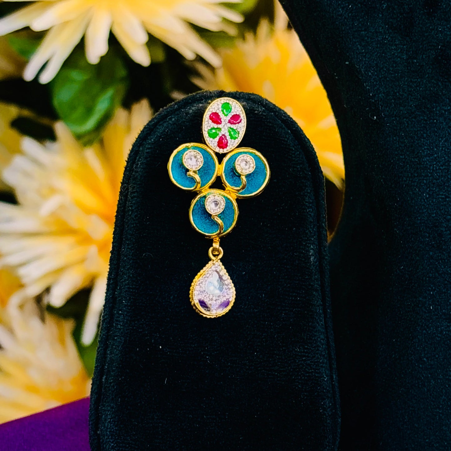 Elegant gold polish silver necklace and blue centerpiece earrings with vibrant multicolor stones.