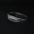 Silver kada featuring embedded black stone for a chic look