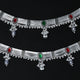 Elegant silver anklet featuring red and green stones and playful ghungroos