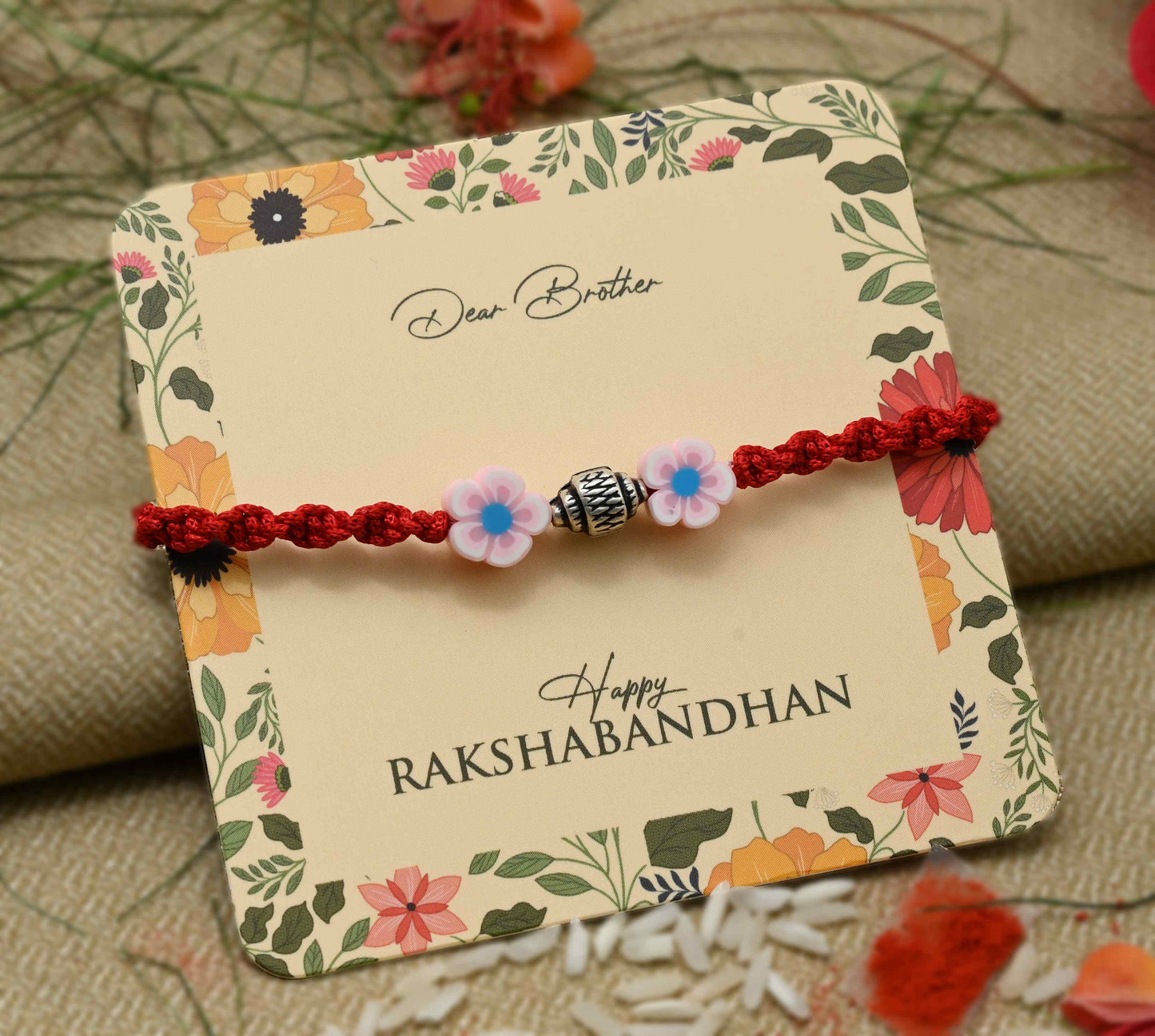 Silver center bead design with pink flowers, perfect Rakhi for boys