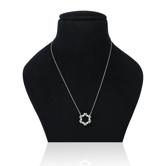 Elegant silver chain with a shiny floral pendant.