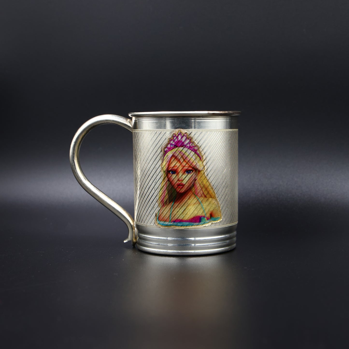 Elegant silver mug with a bright, colorful princess print, ideal for children and collectors.