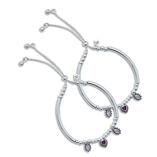 Elegant silver kada anklet with a bold red heart stone for a chic look.
