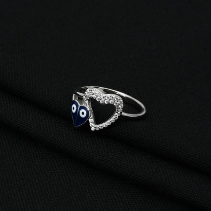 Trendy silver ring showcasing a unique heart shape with evil eye symbols, perfect for adding a touch of charm and protection