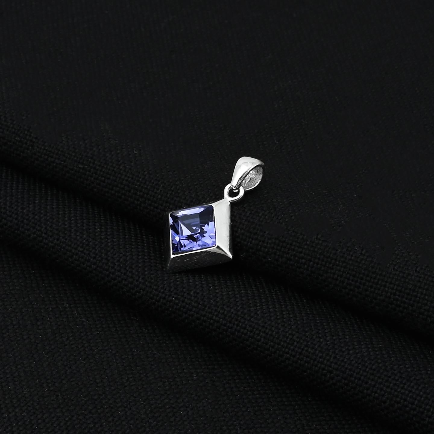 Charming sterling silver pendant with a tilted square design and a beautiful blue solitaire stone