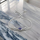 Women's sterling silver bracelet featuring a blue evil eye charm