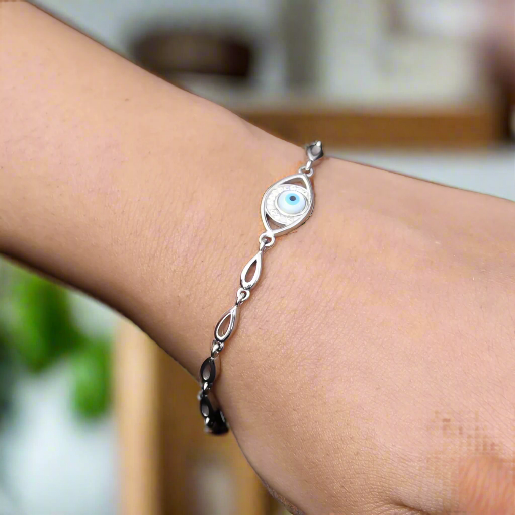 Minimalist silver bracelet with an evil eye charm for protection, perfect as a stylish and meaningful jewelry piece