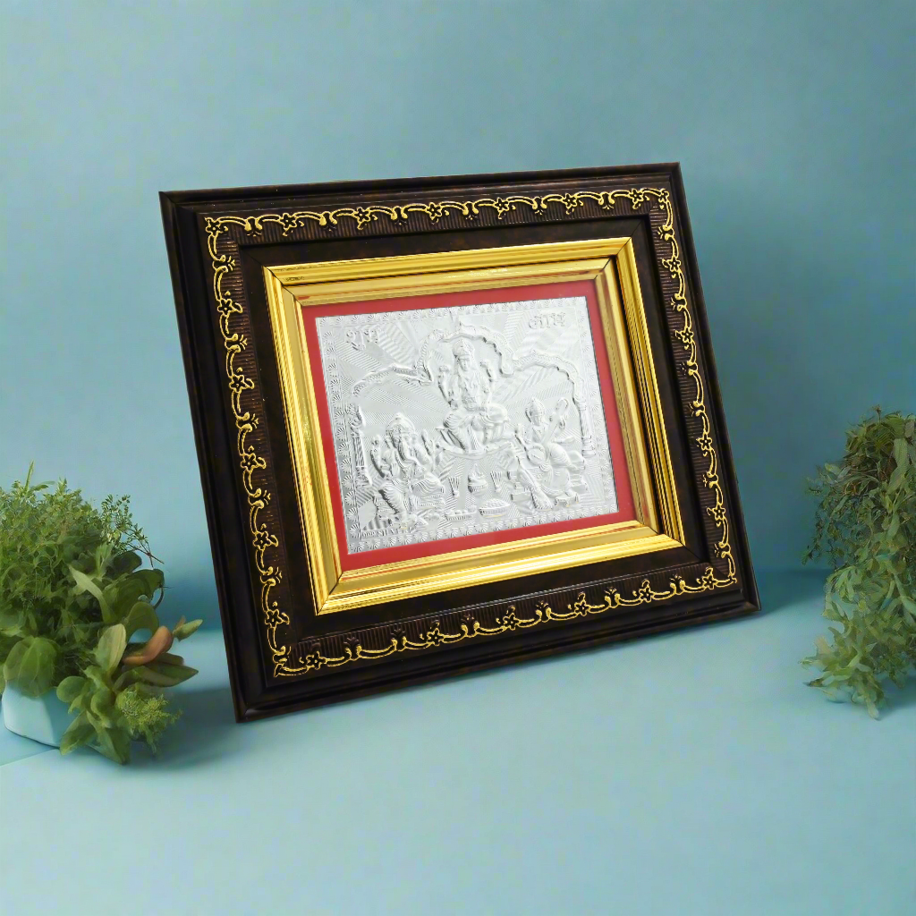 Stunning 999 silver photo frame with Lakshmi, Saraswati, and Ganesha idols, ideal for your spiritual altar