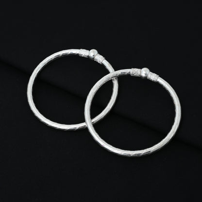 Charming silver baby kada with a timeless design and silver bead centerpiece