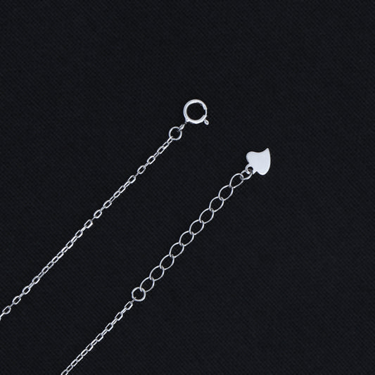 Sleek sterling silver evil eye pendant hanging from a thin chain