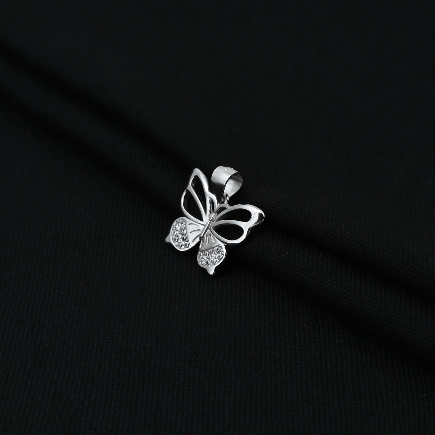 Charming silver pendant showcasing a butterfly motif with small CZ stones