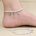 Silver anklet adorned with green and white gemstone beads