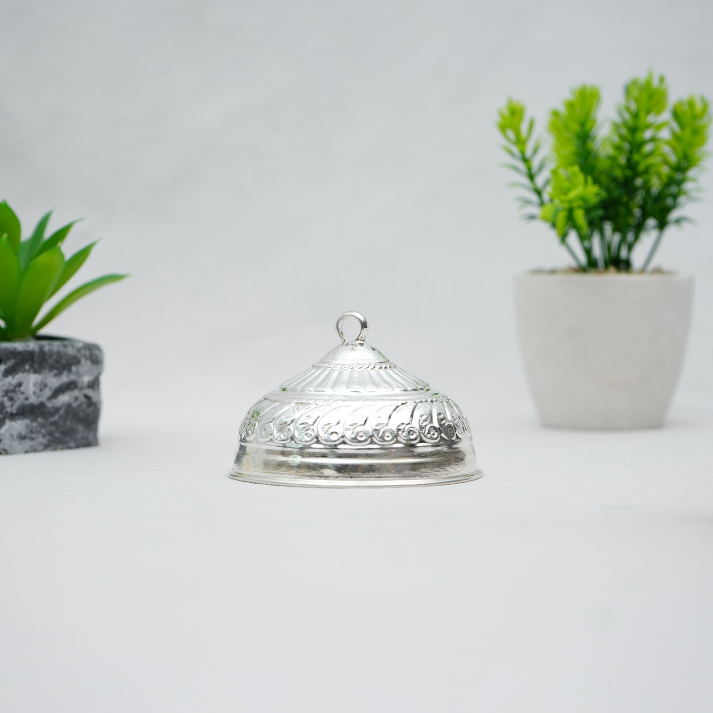 Exquisite silver chattar, intricately designed for temple decoration and rituals.