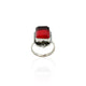 Close-up of a silver ring with a striking rectangular red stone, offering a regal and sophisticated appearance.