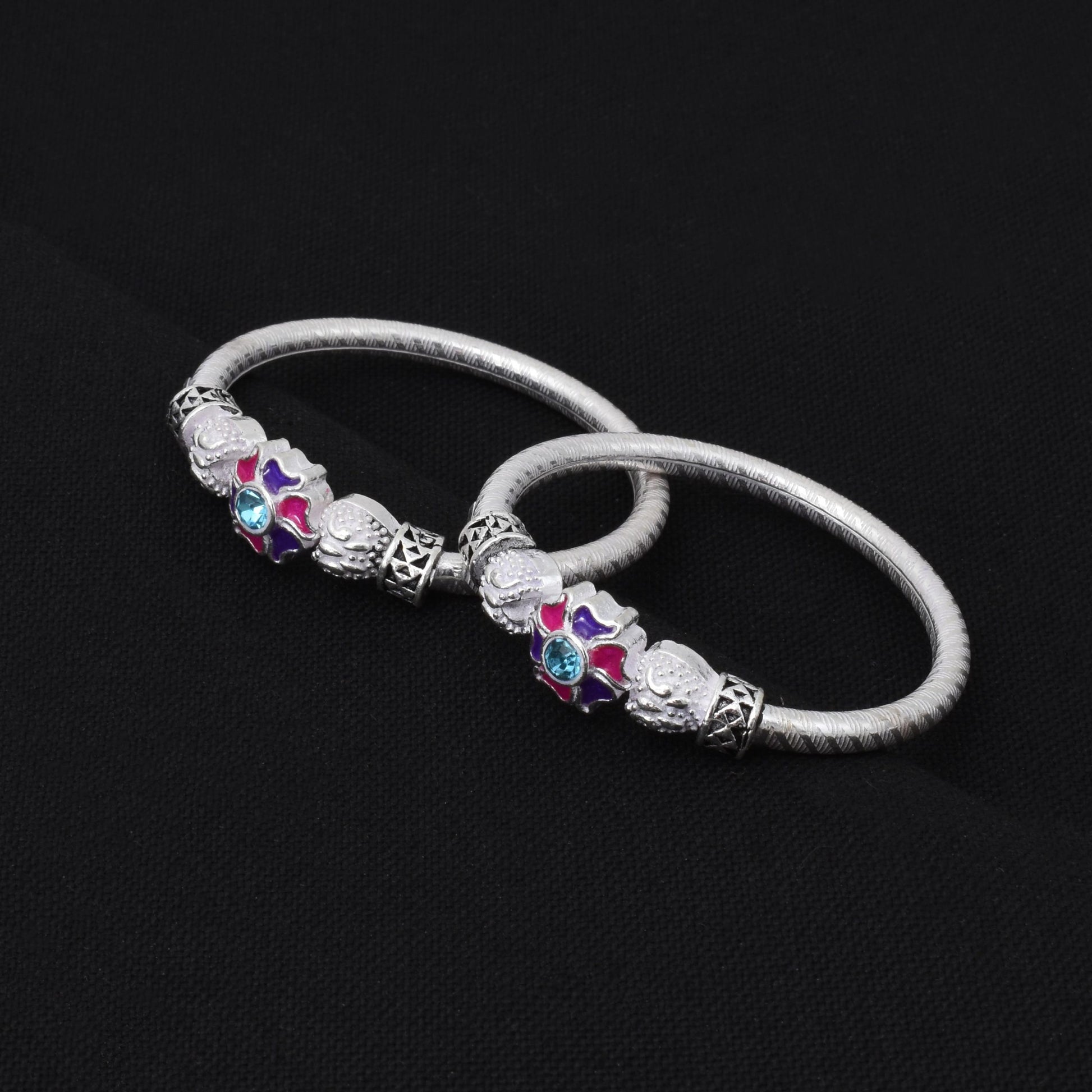 Charming silver baby kada adorned with floral and round motif accents