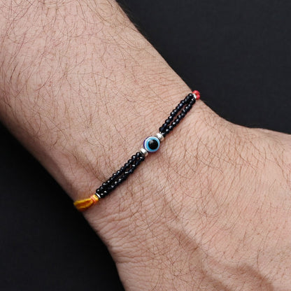 Protective Evil Eye symbol with silver and blue beads, perfect Rakhi for boys.