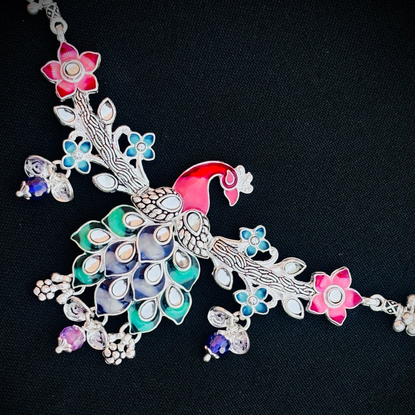 Multicolor flower peacock design silver payal for traditional occasions.