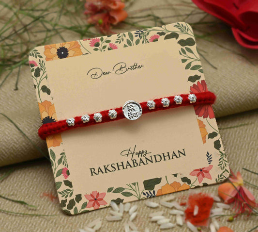 Silver center Rakhi with 'Mere Bhaiya' inscription and a flower design, perfect for boys
