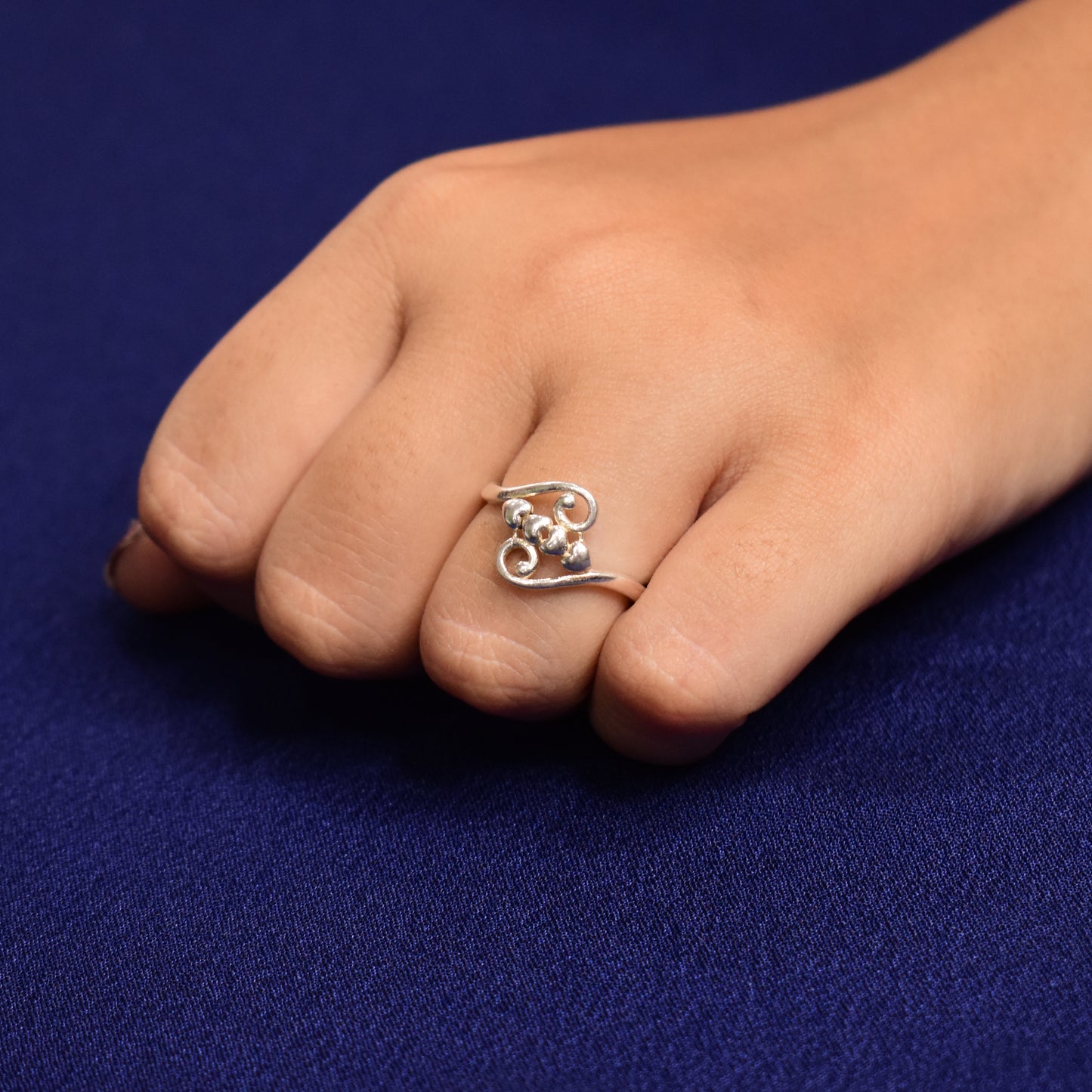 Elegant ring adorned with four heart accents.