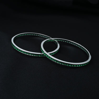 Charming silver bangles featuring green stones, perfect for girls