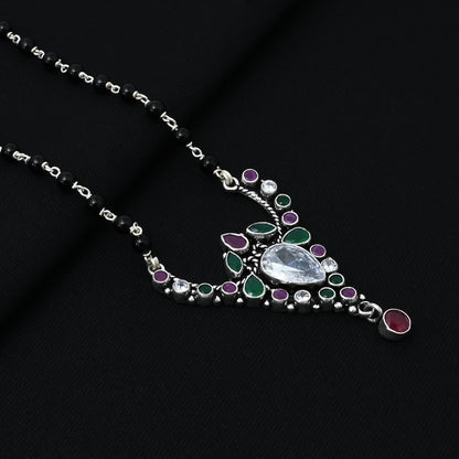 Timeless silver mangalsutra for girls with a beautiful drop design, showcasing green and purple stones