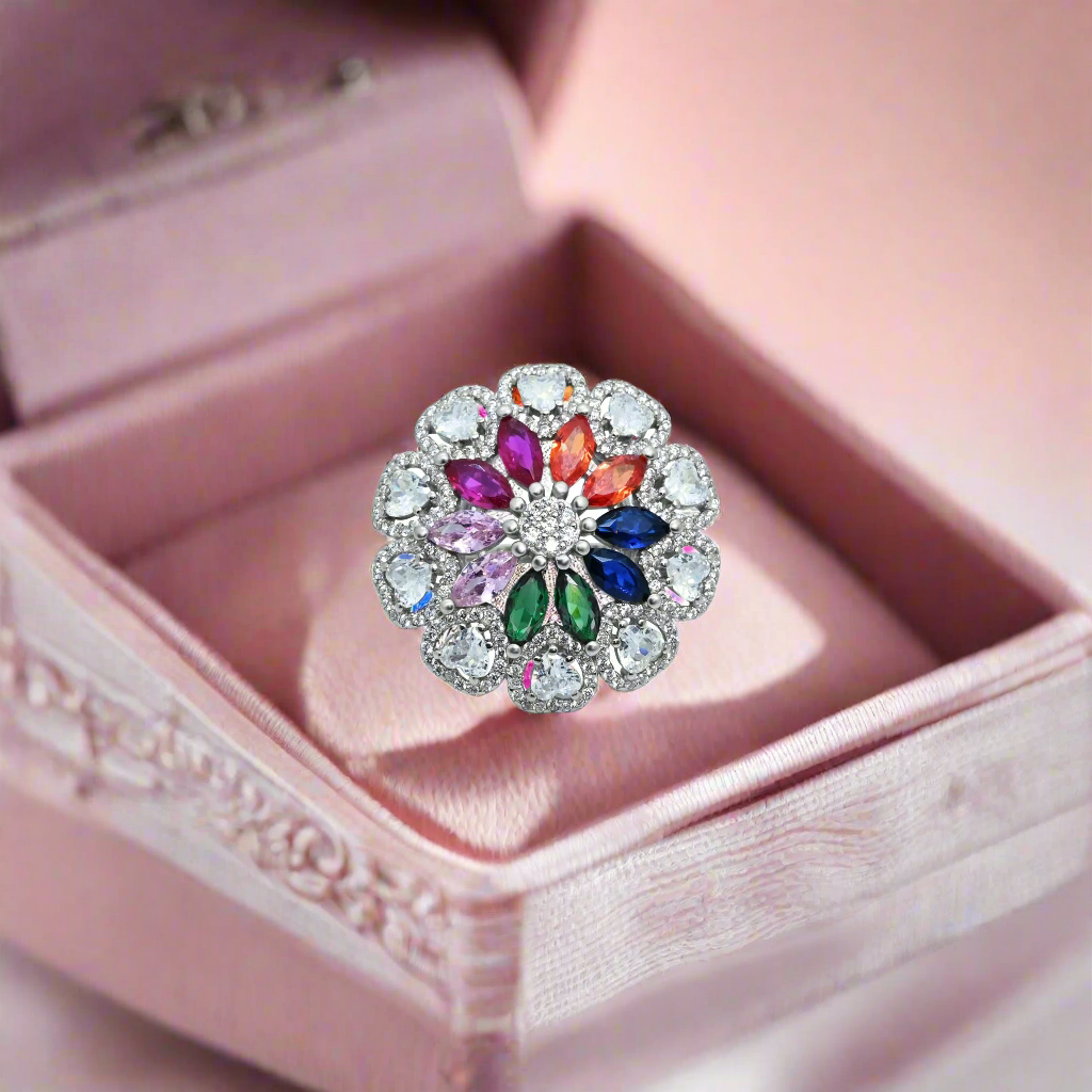 Close-up of a silver ring with a stunning floral pattern, showcasing a mix of bright, colorful gemstones.