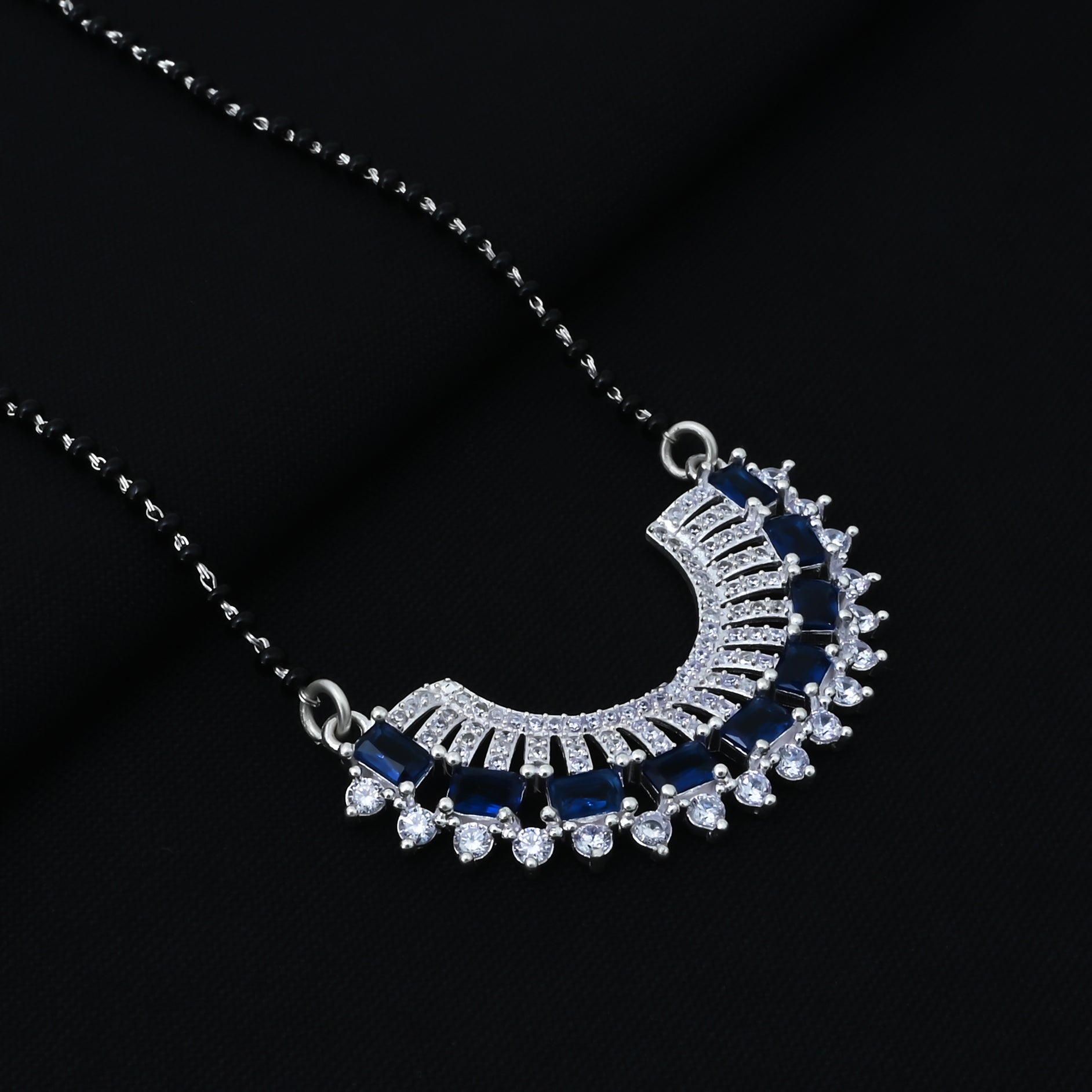 Timeless silver mangalsutra for girls, adorned with a vibrant blue gemstone in a unique design