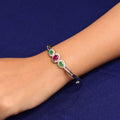 Elegant girls' silver kada adorned with a vibrant multicolor gemstone design