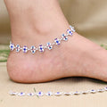 Silver anklet adorned with vibrant floral pearls.