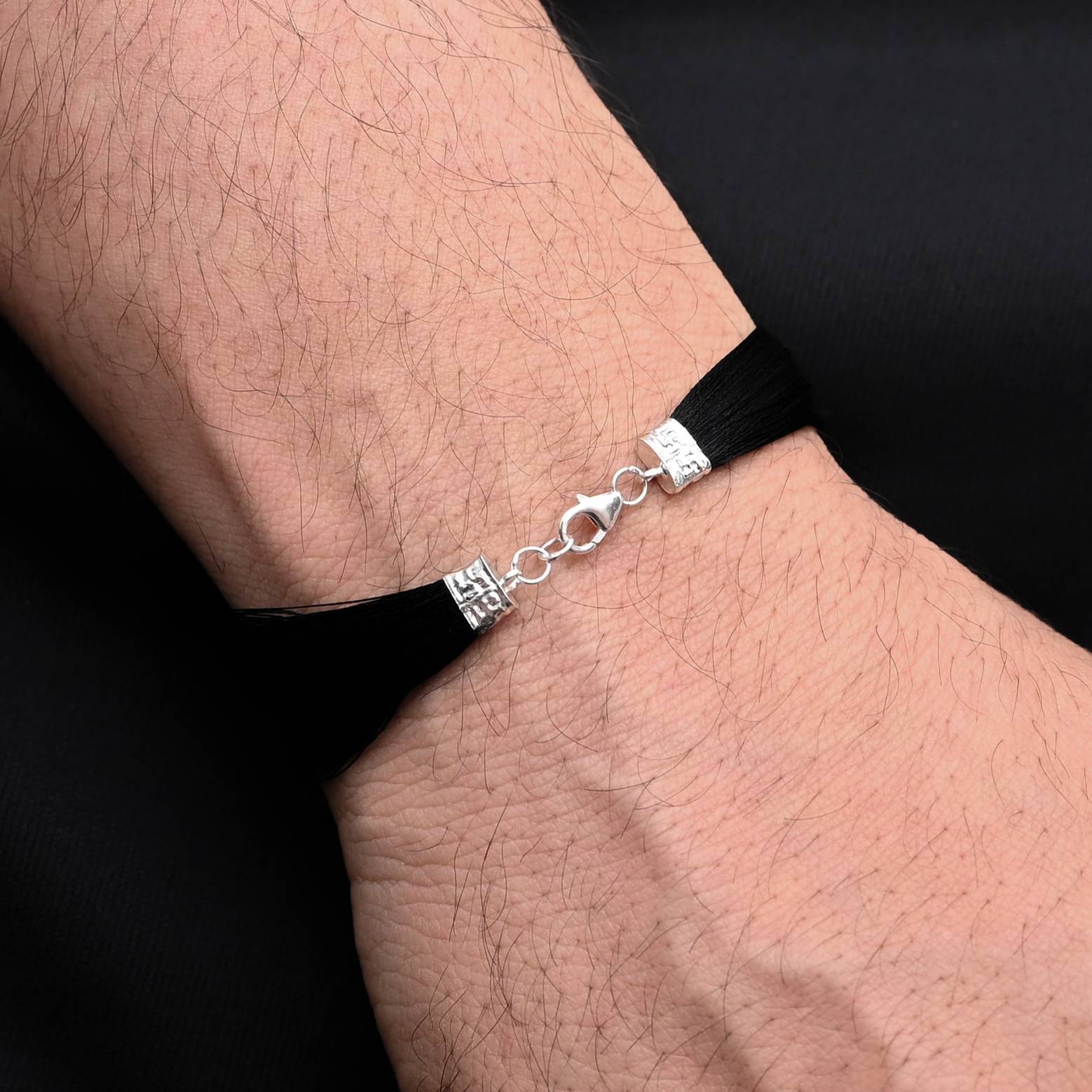 Timeless silver moli bracelet for men, showcasing a classic black thread for a refined touch