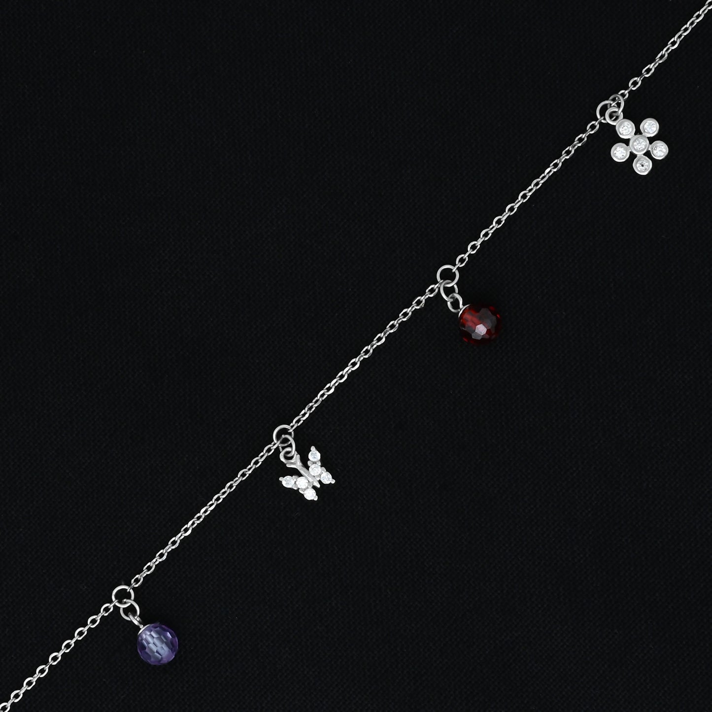 Stylish bracelet for girls, combining a butterfly and flower design with a polished silver finish.