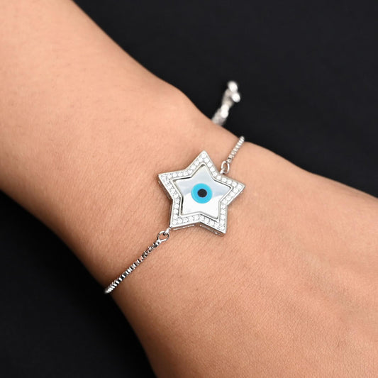 Silver bracelet for girls featuring a shiny star charm and a protective evil eye