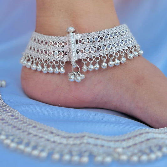 Traditional heavy silver payal with stones and ghungroos.