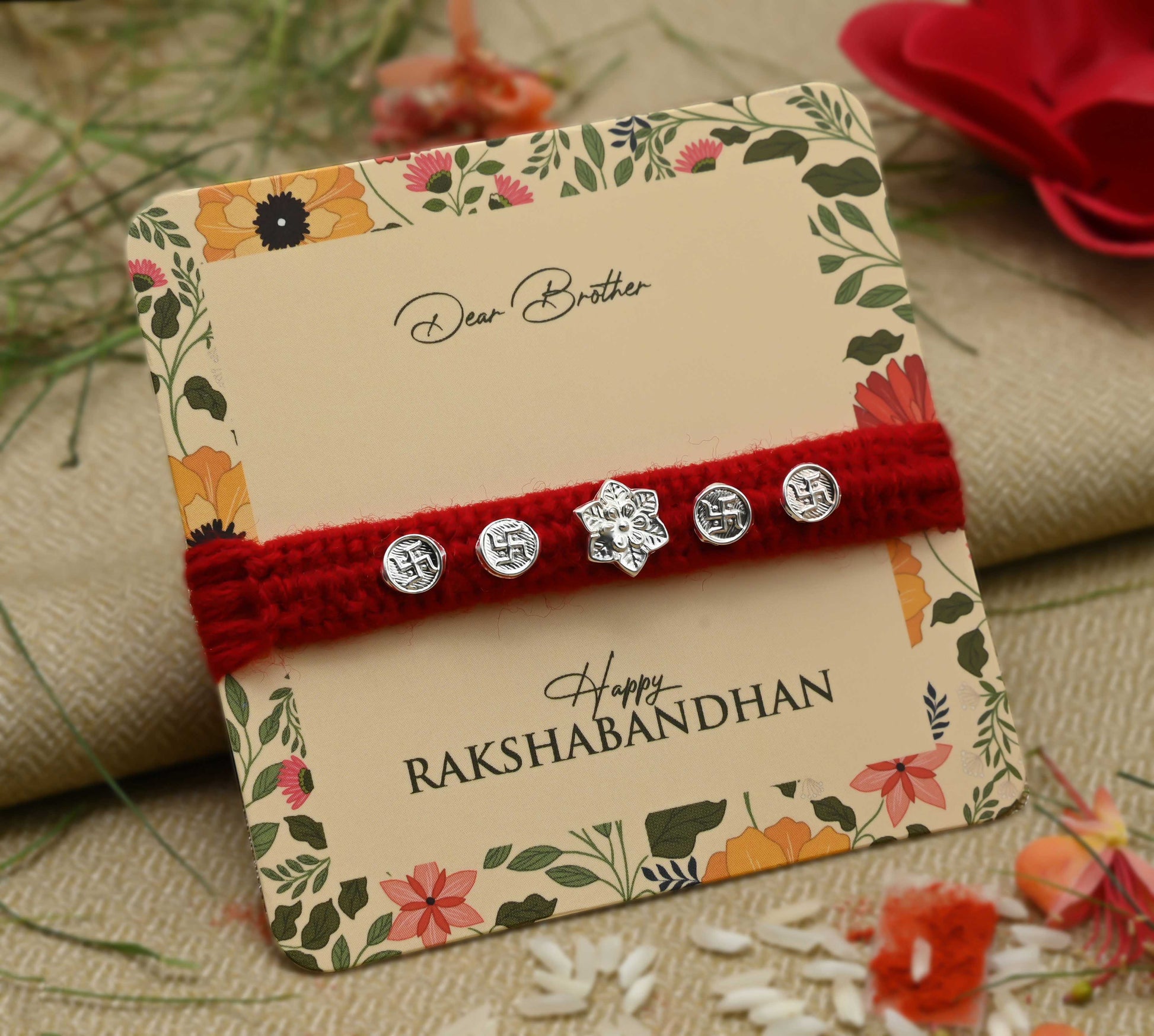Silver center flower design with Swasthik symbol, perfect Rakhi for boys.