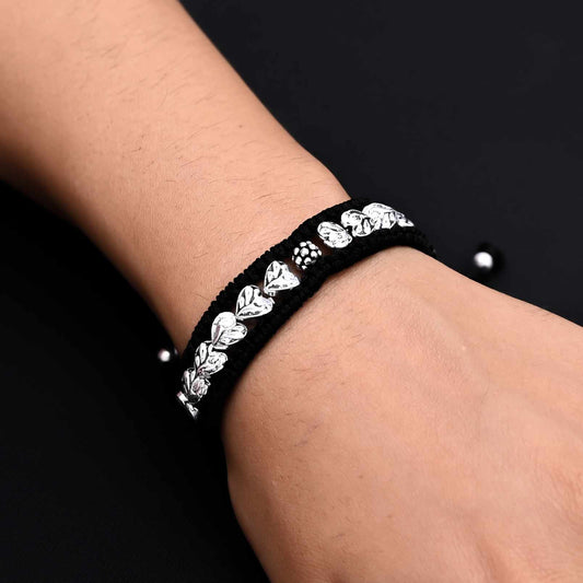 Men's silver bracelet featuring an intricate leaves design and silver beads