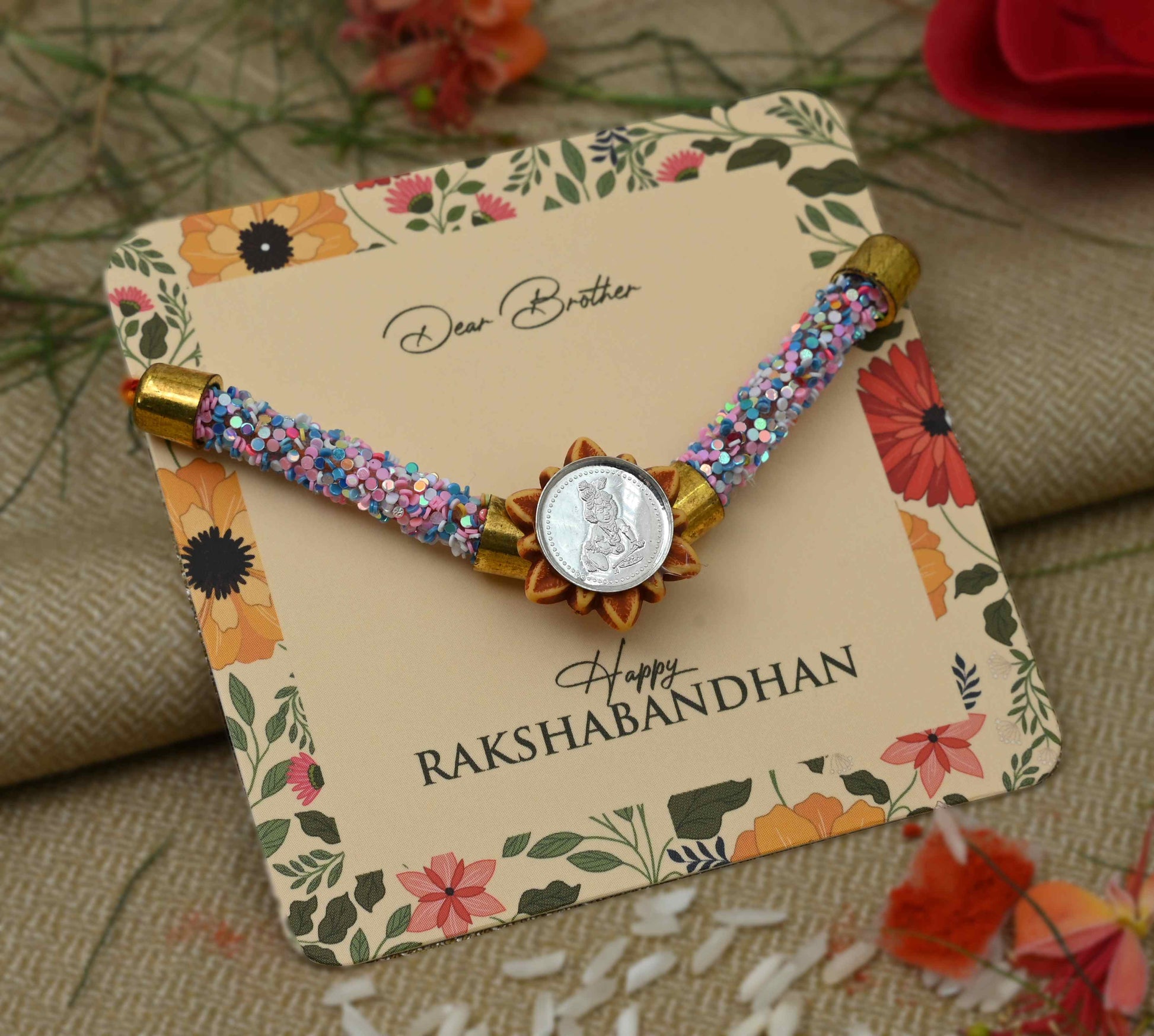 Silver Baal Gopal centerpiece with pink and blue flat circular beads Rakhi for boys.