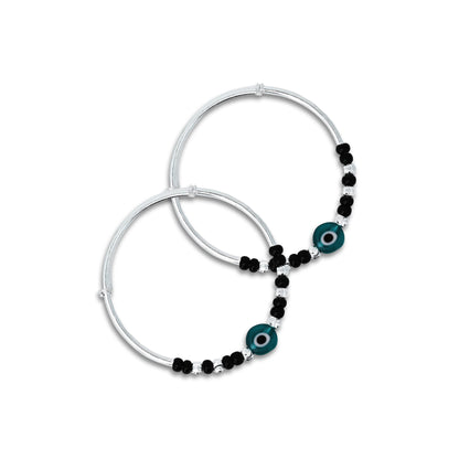 Baby silver kada payal featuring a green evil eye with black and silver beads.