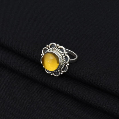 Stylish silver ring with a beautiful golden gem, perfect for enhancing any outfit with a warm and rich glow.