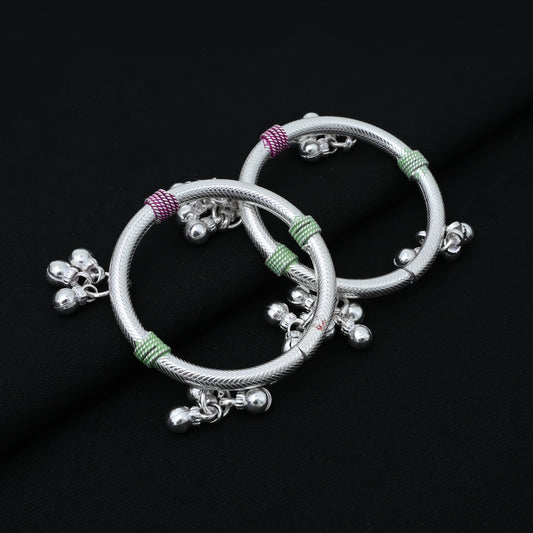 Charming silver baby kada with vibrant pink and green charm details